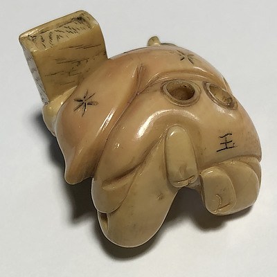 Japanese Carved Ivory Netsuke of a Man Holding a Box