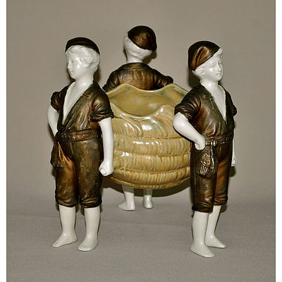 Austrian Amphora Porcelain Centrepiece. Conch shell supported by three fishermen, painted in bronze & yellow. Incl. an Eichwald earthenware compressed oval vase with moulded floral decoration on matt green ground.
