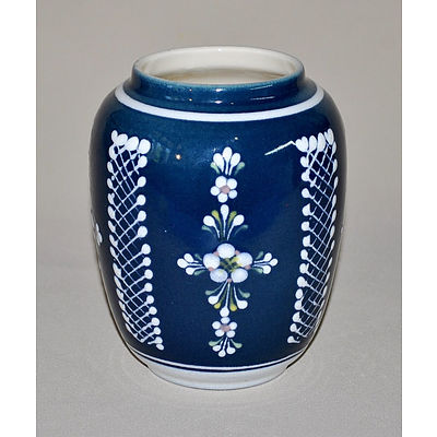 Austrian Amphora Porcelain Centrepiece. Conch shell supported by three fishermen, painted in bronze & yellow. Incl. an Eichwald earthenware compressed oval vase with moulded floral decoration on matt green ground.