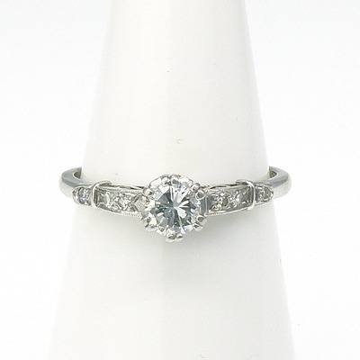 18ct Platinum Ring with Round Brilliant Cut Diamond in Six Double Claw Setting with Uplifted Shoulders each with Three Single Cut Diamonds