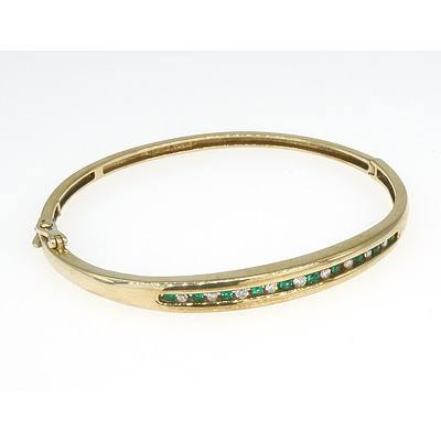 9ct Yellow Hold Hinged Bangle with a Row of Round Synthetic Green Emeralds and Round Brilliant Cut Diamonds