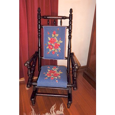An Antique Ebonized Oak Rocking Chair with Tapestry Upholstery