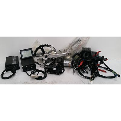 Assorted Box Of Electric Bike Accesories Including Battery Chargers, Hubs & More.