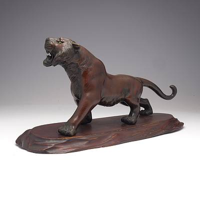 Japanese Patinated Bronze Model of a Stalking Tiger on a Carved Wood Base, Meiji Period 1868-1912