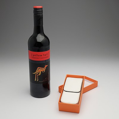 White leather pen case and bottle of wine