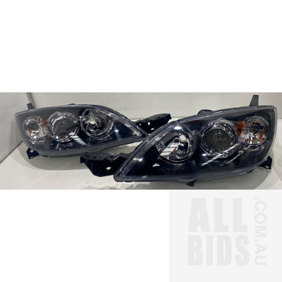 Pair of TYC 20-A860 Mazda 3 Headlights,
