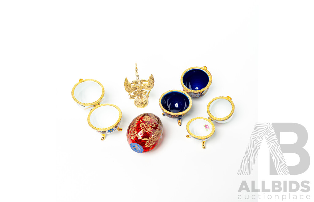 Collection Four Lidded Ceramic Eggs and Ruby Crystal with Etched Floral Detail Example Labeled Faberge to Base on Brass Stand