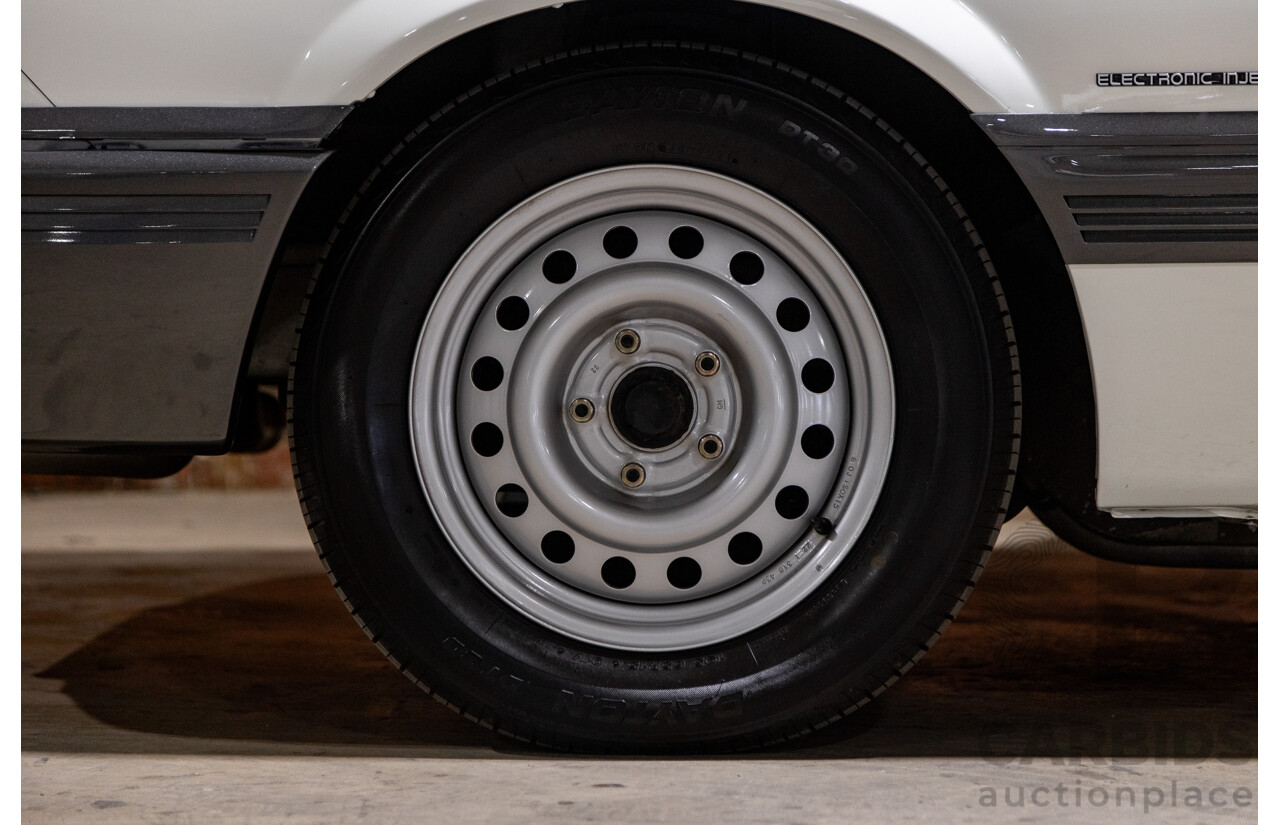 6/1987 Holden Commodore VL Turbo SL BT1 4d Sedan White Turbo 3.0L - Ex-Police - Modified