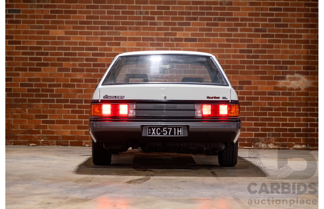 6/1987 Holden Commodore VL Turbo SL BT1 4d Sedan White Turbo 3.0L - Ex-Police - Modified