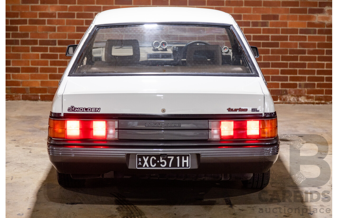 6/1987 Holden Commodore VL Turbo SL BT1 4d Sedan White Turbo 3.0L - Ex-Police - Modified
