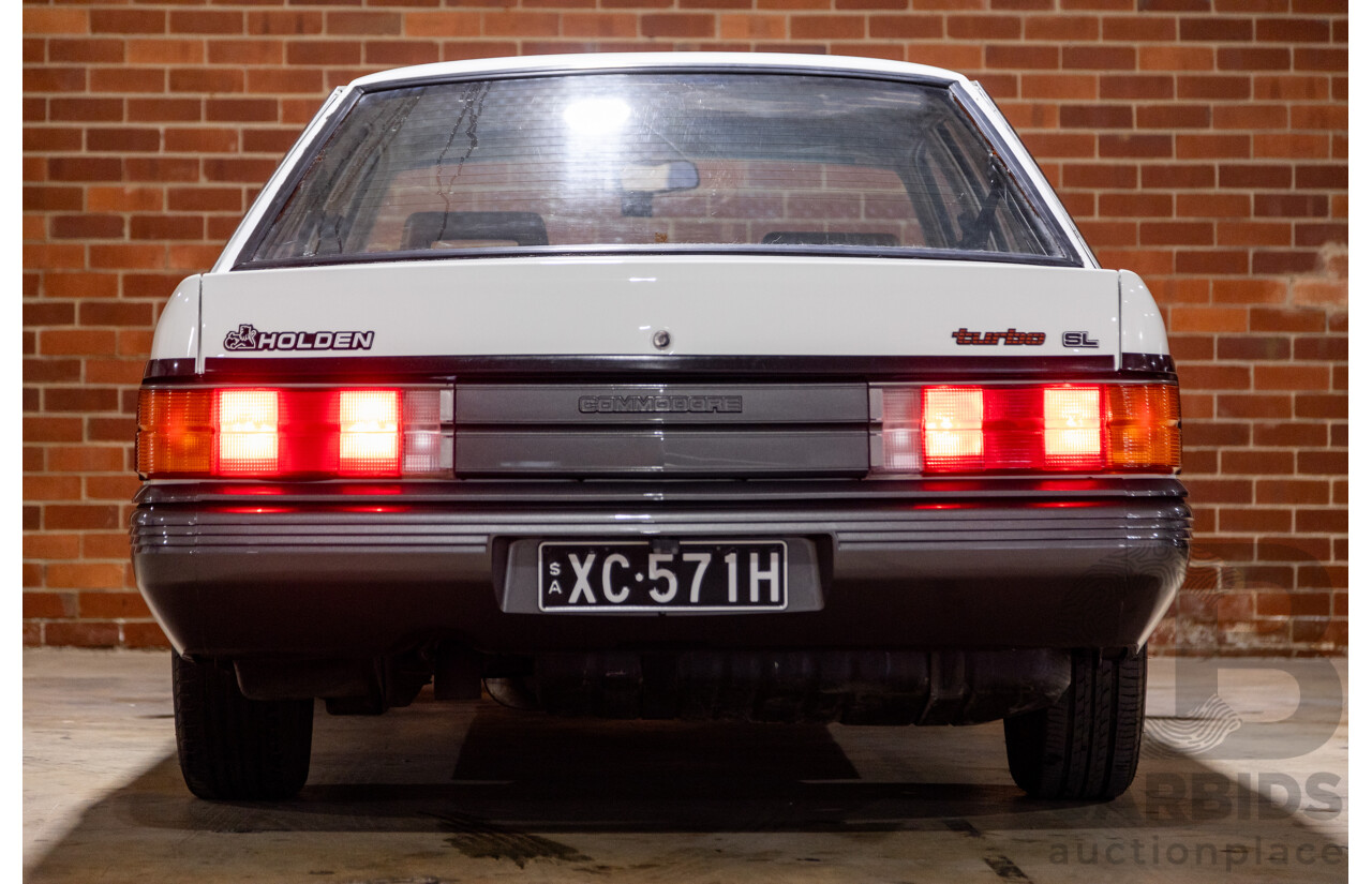 6/1987 Holden Commodore VL Turbo SL BT1 4d Sedan White Turbo 3.0L - Ex-Police - Modified