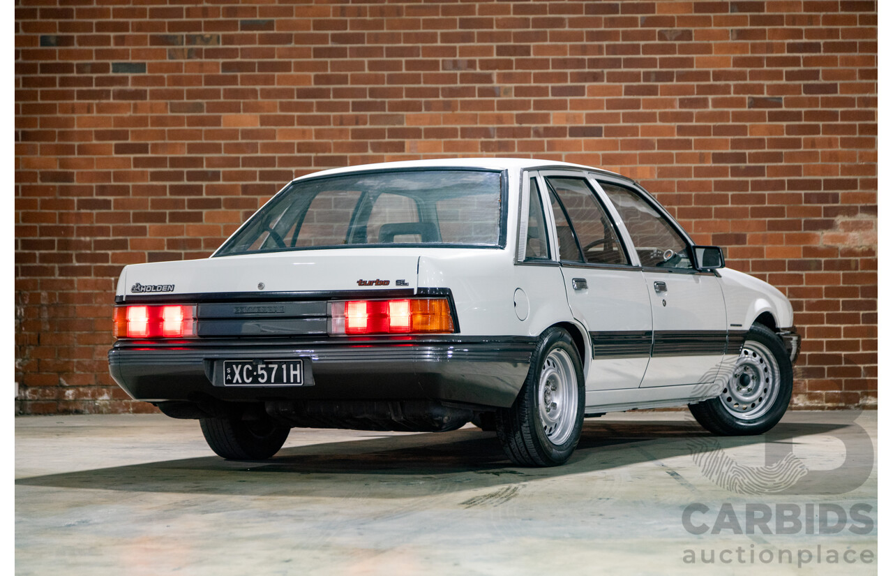 6/1987 Holden Commodore VL Turbo SL BT1 4d Sedan White Turbo 3.0L - Ex-Police - Modified