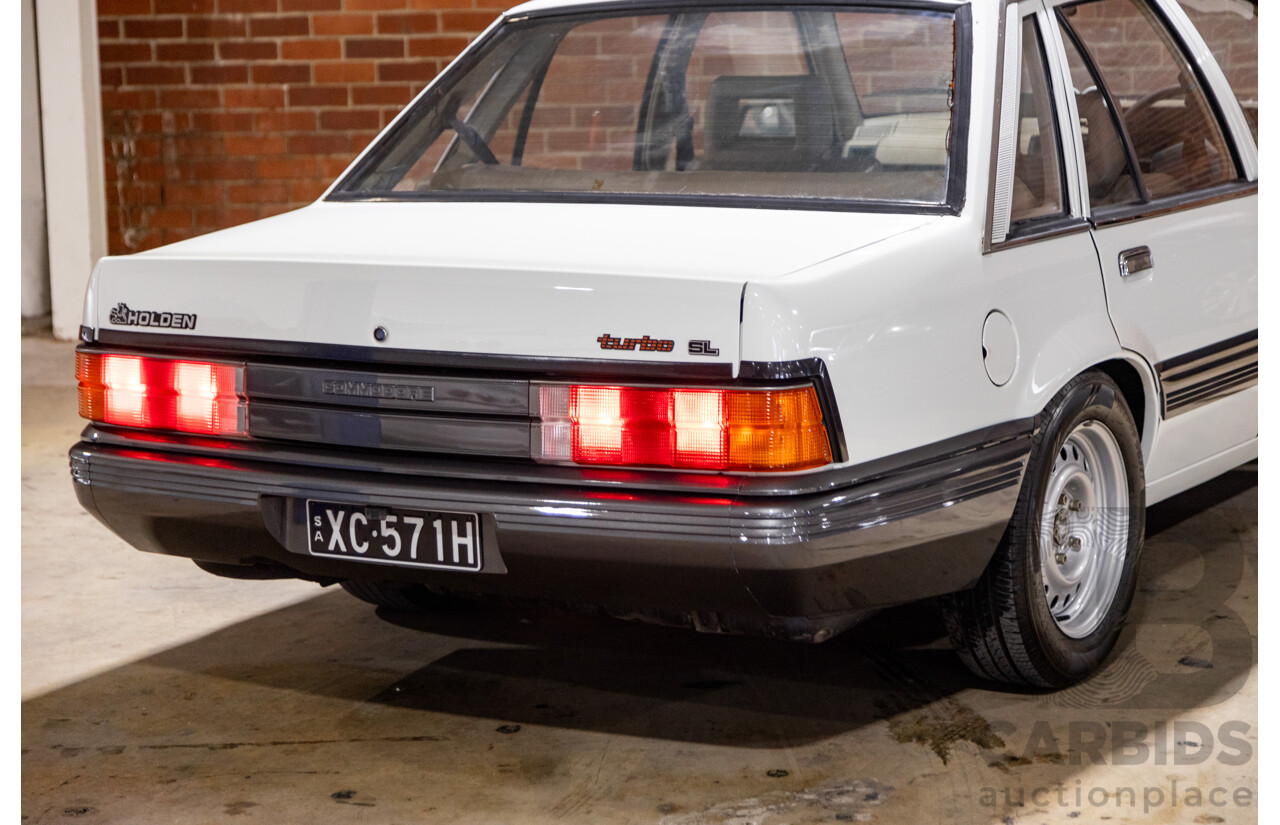 6/1987 Holden Commodore VL Turbo SL BT1 4d Sedan White Turbo 3.0L - Ex-Police - Modified