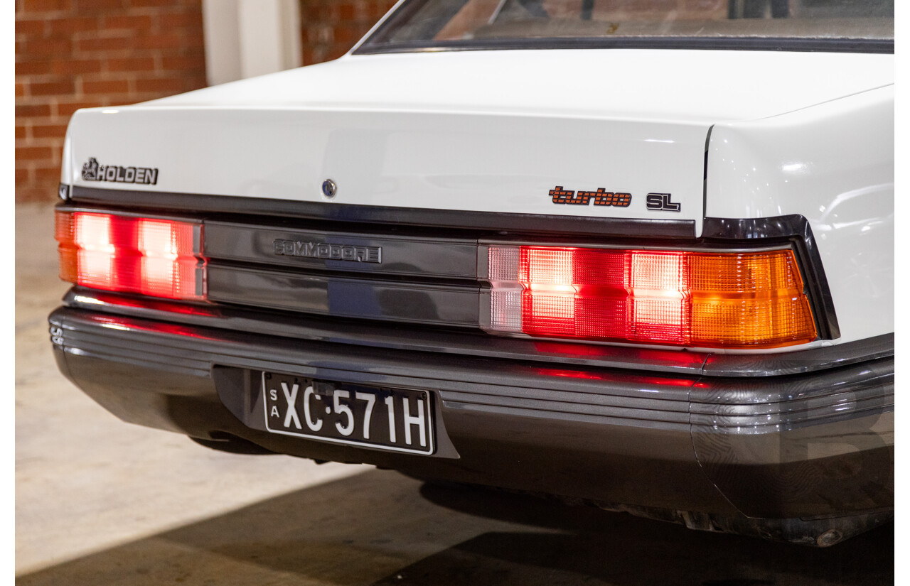 6/1987 Holden Commodore VL Turbo SL BT1 4d Sedan White Turbo 3.0L - Ex-Police - Modified