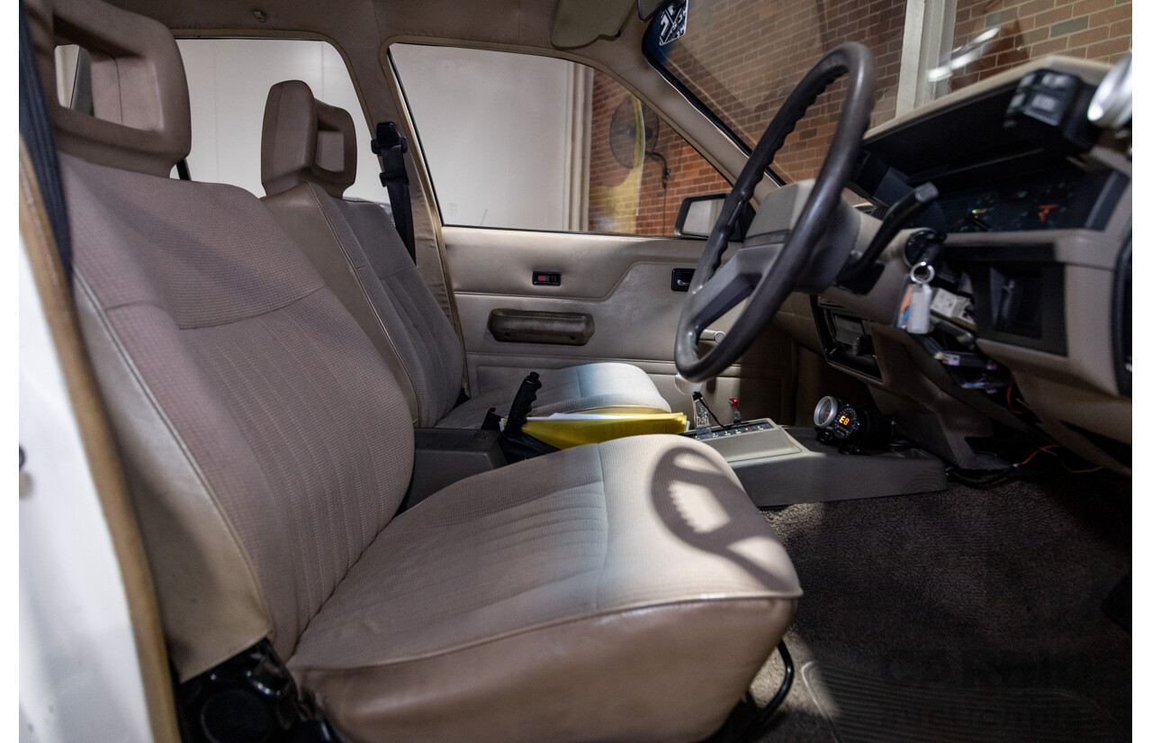 6/1987 Holden Commodore VL Turbo SL BT1 4d Sedan White Turbo 3.0L - Ex-Police - Modified