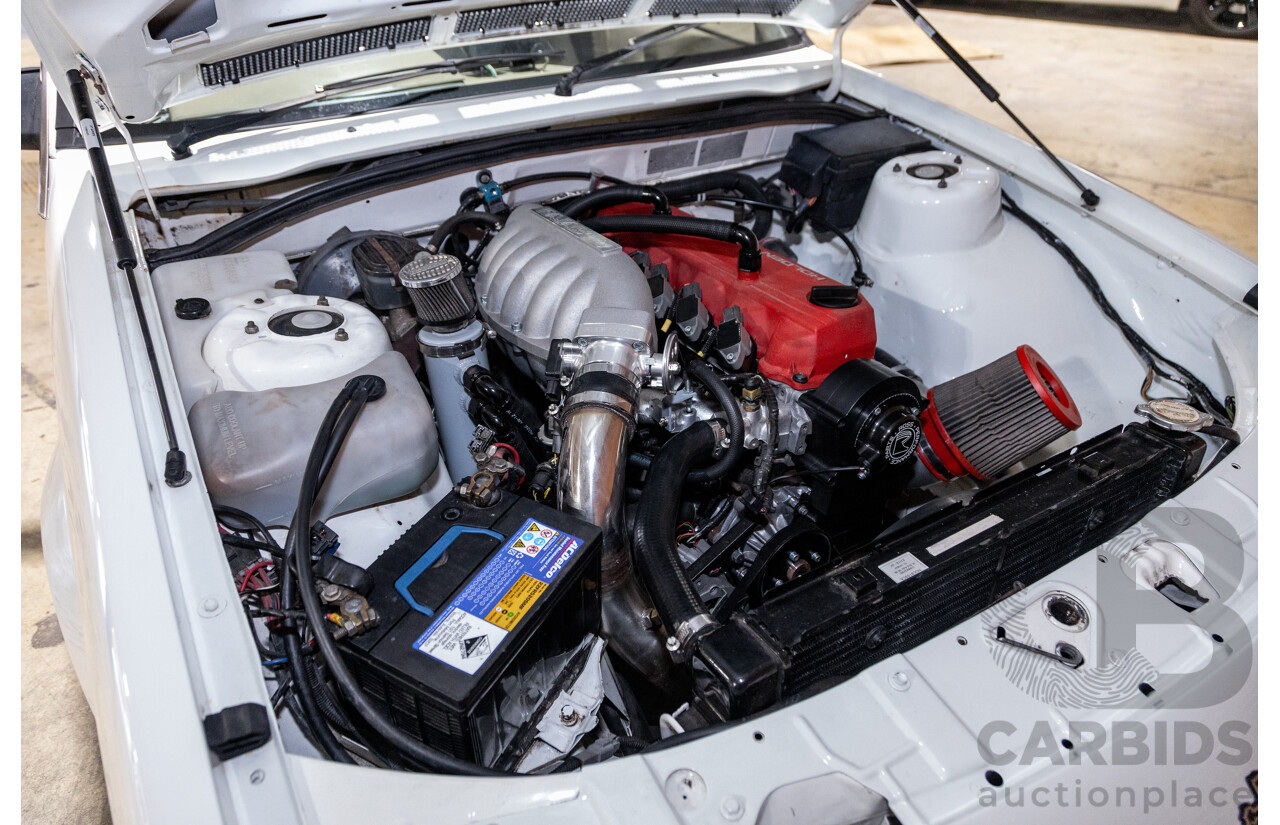 6/1987 Holden Commodore VL Turbo SL BT1 4d Sedan White Turbo 3.0L - Ex-Police - Modified