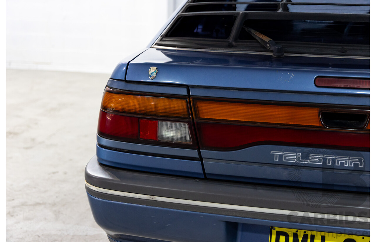 7/1990 Ford Telstar TX5 GHIA AV 5d Hatchback Jeans Blue 2.2L