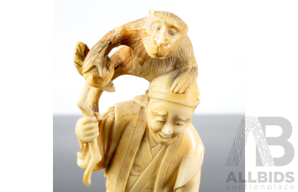 Antique Japanese Hand Carved Ivory Okimono of Man with Sickle and Monkey