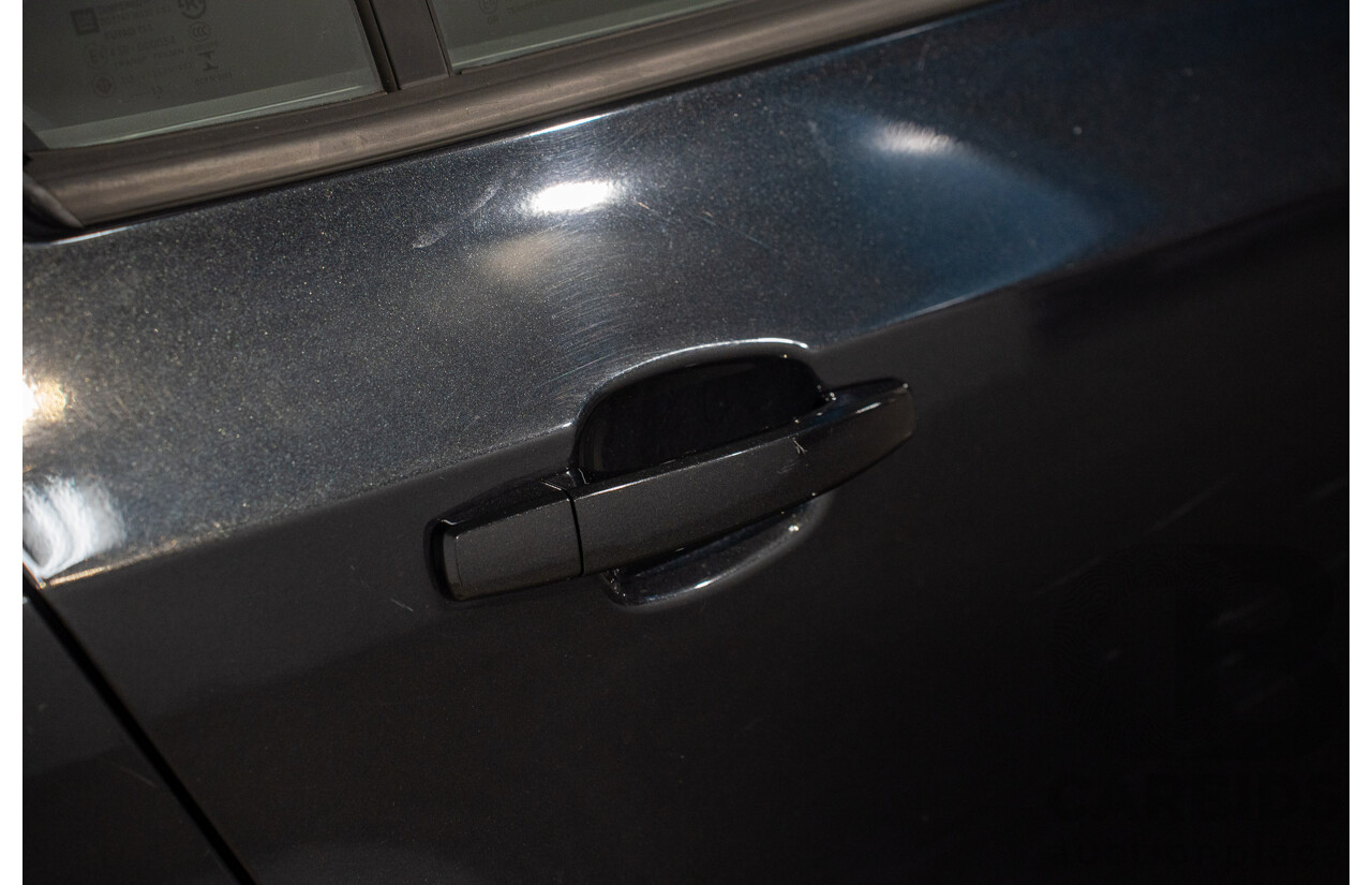 5/2013 Holden Barina CD TM MY13 4d Sedan Carbon Flash Metallic 1.6L