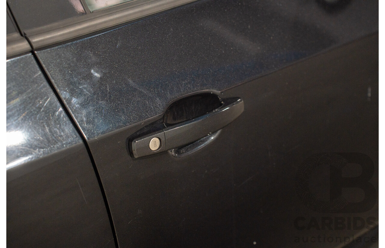 5/2013 Holden Barina CD TM MY13 4d Sedan Carbon Flash Metallic 1.6L