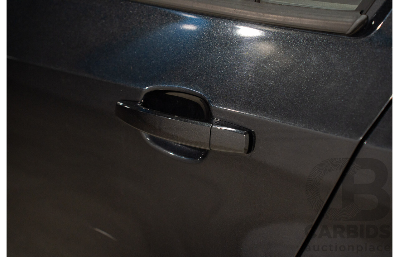 5/2013 Holden Barina CD TM MY13 4d Sedan Carbon Flash Metallic 1.6L