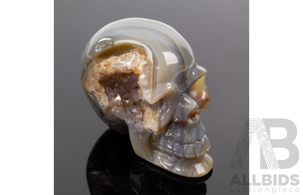 Carved Polished Banded Agate Stone Memento Mori Half Skull with Crystal Cave to One Side