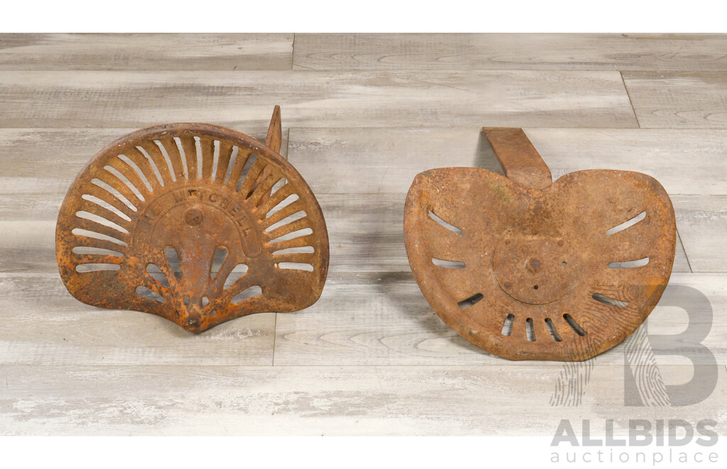 Two Antique Tractor Seats Including The Mitchell Cast Iron and Pressed Steel Example