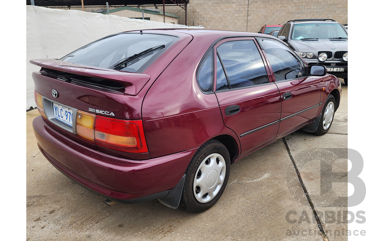 5/1999 Toyota Corolla Conquest SECA AE102R 5d Liftback Maroon 1.8L