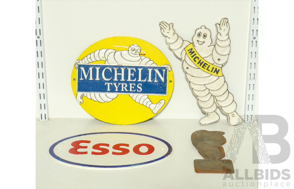 Collection of Cast Iron Wall Mounts Including Two Esso and Two Michelin Tires