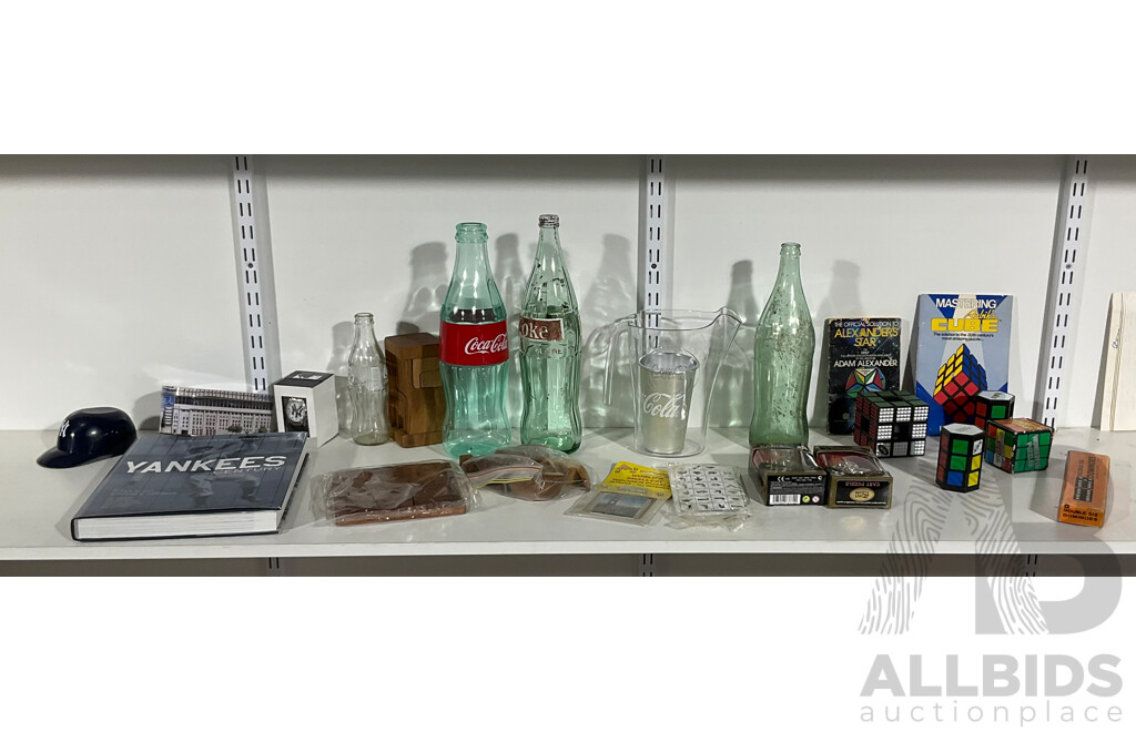 Collection of Coca Cola Collectables Including Vintage Bottles, Rubiks Cubes, Timber Puzzles, Dominoes, New York Yankees Watch, Book, Display Cap