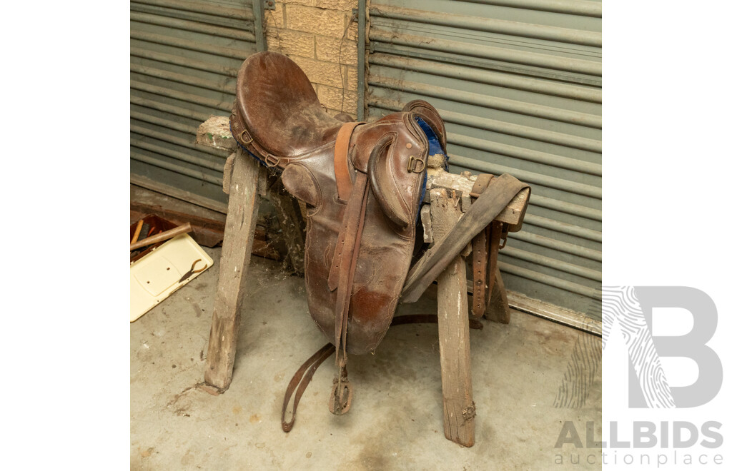 17" Unbranded Stock Saddle with Stirrups & Girth on Saw Horse