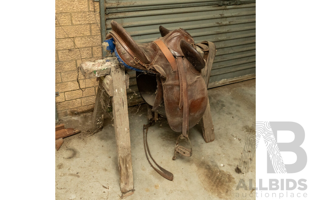 17" Unbranded Stock Saddle with Stirrups & Girth on Saw Horse