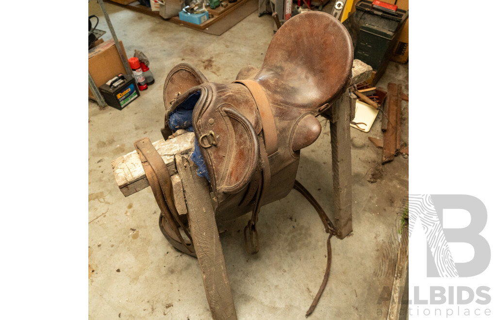 17" Unbranded Stock Saddle with Stirrups & Girth on Saw Horse