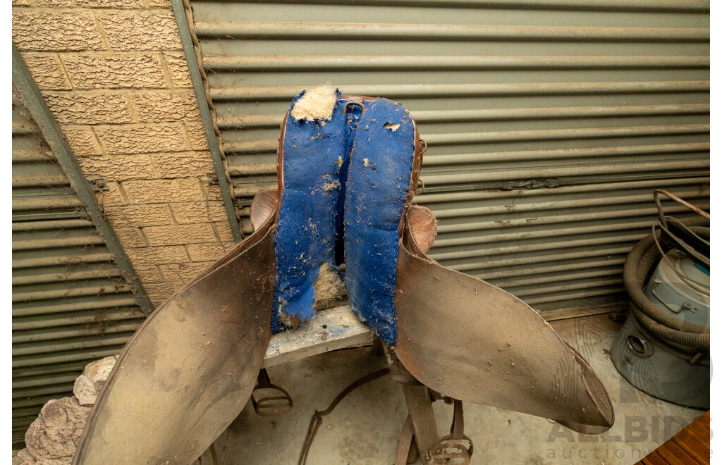 17" Unbranded Stock Saddle with Stirrups & Girth on Saw Horse