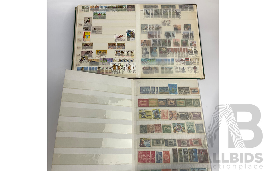 Two Albums of Antique and Vintage International Mint and Cancelled Stamps Including Zanzibar Nigeria, Guernsey, Zimbabwe, Zaire, Uruguay, Paraguay, Mexico, Brazil, Guyana, Colombia and More