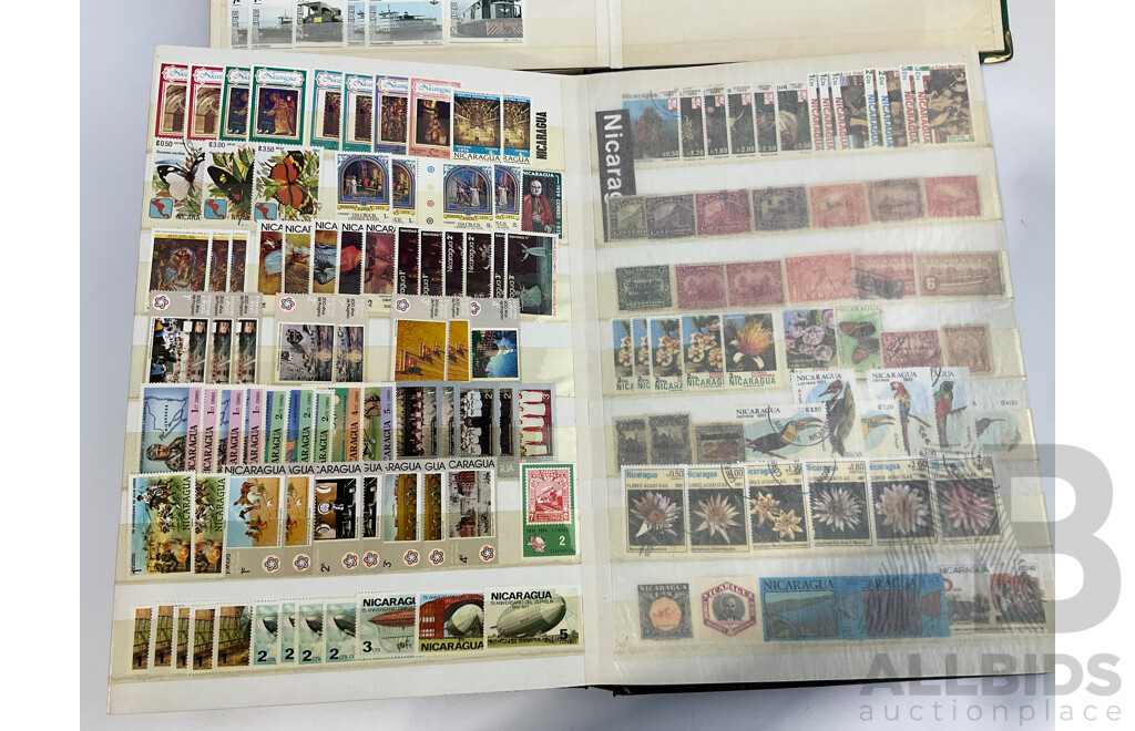 Two Albums of Antique and Vintage International Mint and Cancelled Stamps Including Zanzibar Nigeria, Guernsey, Zimbabwe, Zaire, Uruguay, Paraguay, Mexico, Brazil, Guyana, Colombia and More