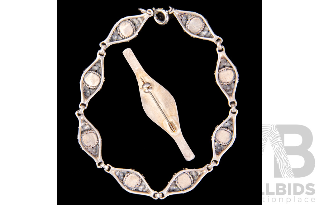 Sterling Silver Garnet Set Bracelet and Brooch Eight Link Bracelet with Floral Design, Each Link Set with Oval Garnet. Together with a Matching Bar Brooch.