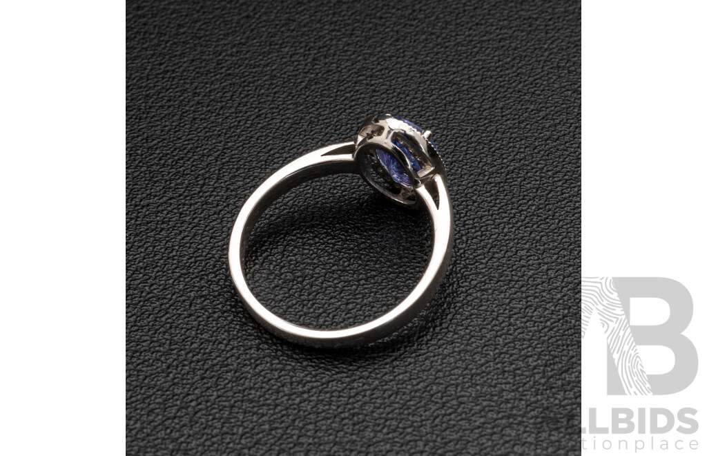 BRAND NEW - 9ct White Gold Tanzanite & Diamond Halo Ring, S1.40ct/TDW0.165ct, Size M, 2.72 Grams