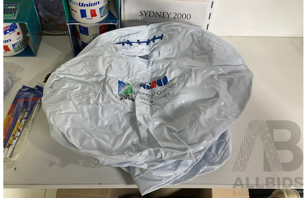 Collection of Sporting Goods Including Four 2003 Rugby World Cup Inflatable Footballs, Two Boxed Mugs, Boxed Sydney 2000 Mug and Pen Set, Twenty Five Olympic Poster Cards, 1996 Canberra Raiders Poster