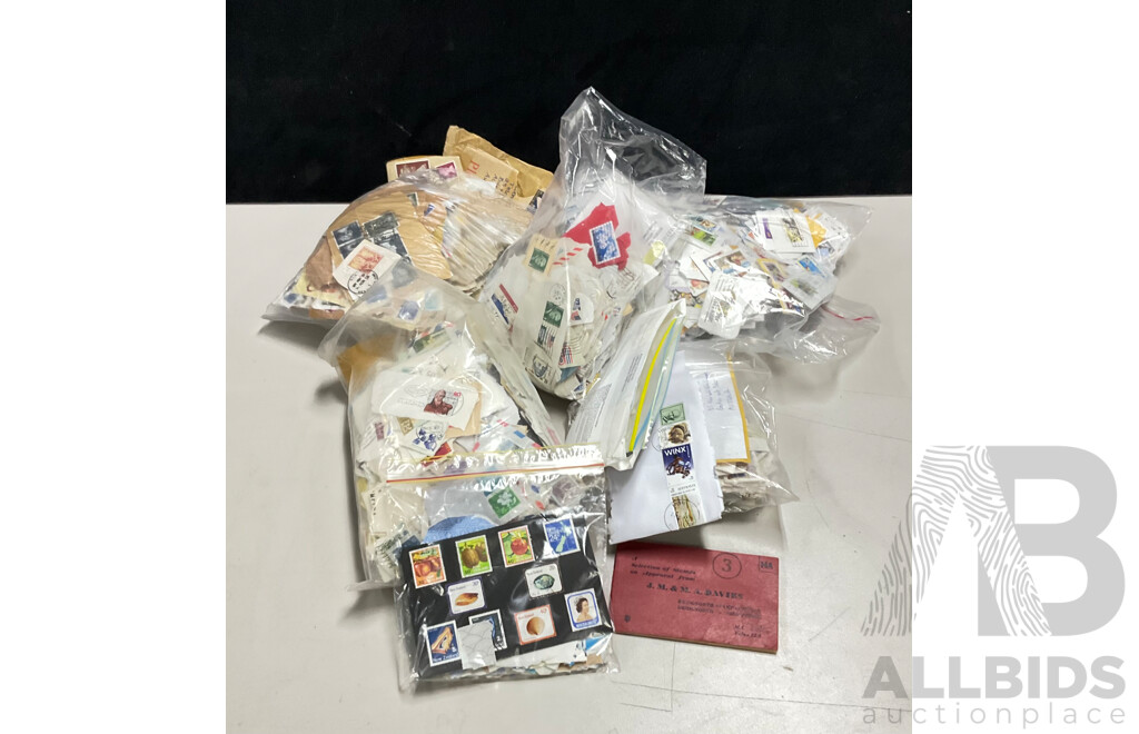 Collection of International Cancelled Stamps Including USA, New Zealand, Australia, UK, Germany, Malaysia, India, Romania, Italy and More - Approximately Two Kilograms