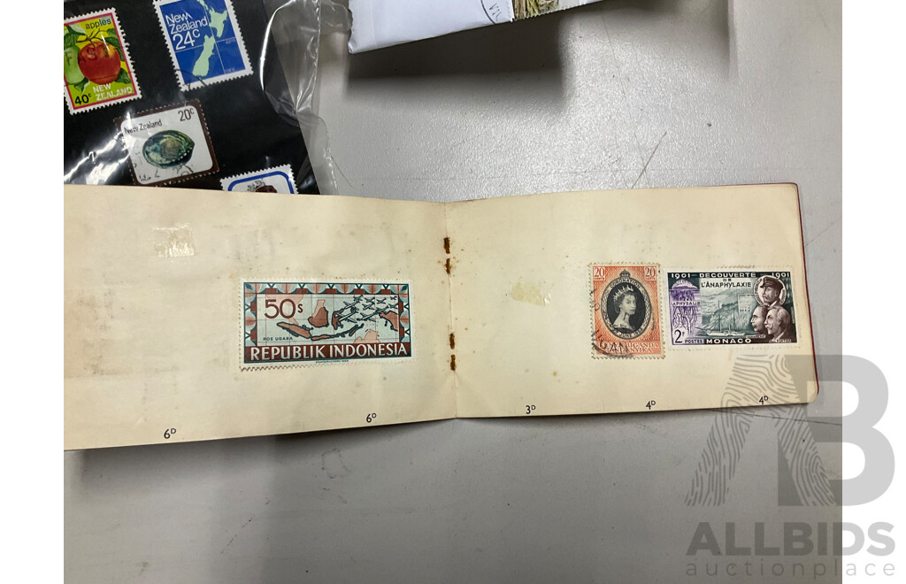 Collection of International Cancelled Stamps Including USA, New Zealand, Australia, UK, Germany, Malaysia, India, Romania, Italy and More - Approximately Two Kilograms