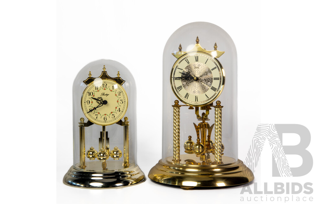 Pair of Graduated Glass Dome Anniversary Clocks with Rotating Pendulum by Prestige