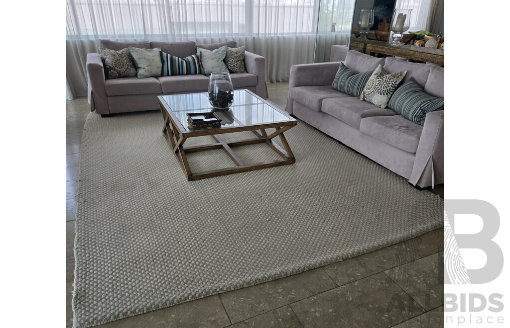 Entire Lounge Room Setting Including 2 X Three Seater Beige Microfibre Lounges, All Cushions, Rib Weave Natural Wool Rug and Designer Cross Base Glass Coffee Table