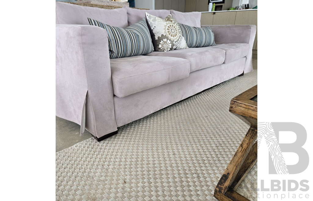 Entire Lounge Room Setting Including 2 X Three Seater Beige Microfibre Lounges, All Cushions, Rib Weave Natural Wool Rug and Designer Cross Base Glass Coffee Table