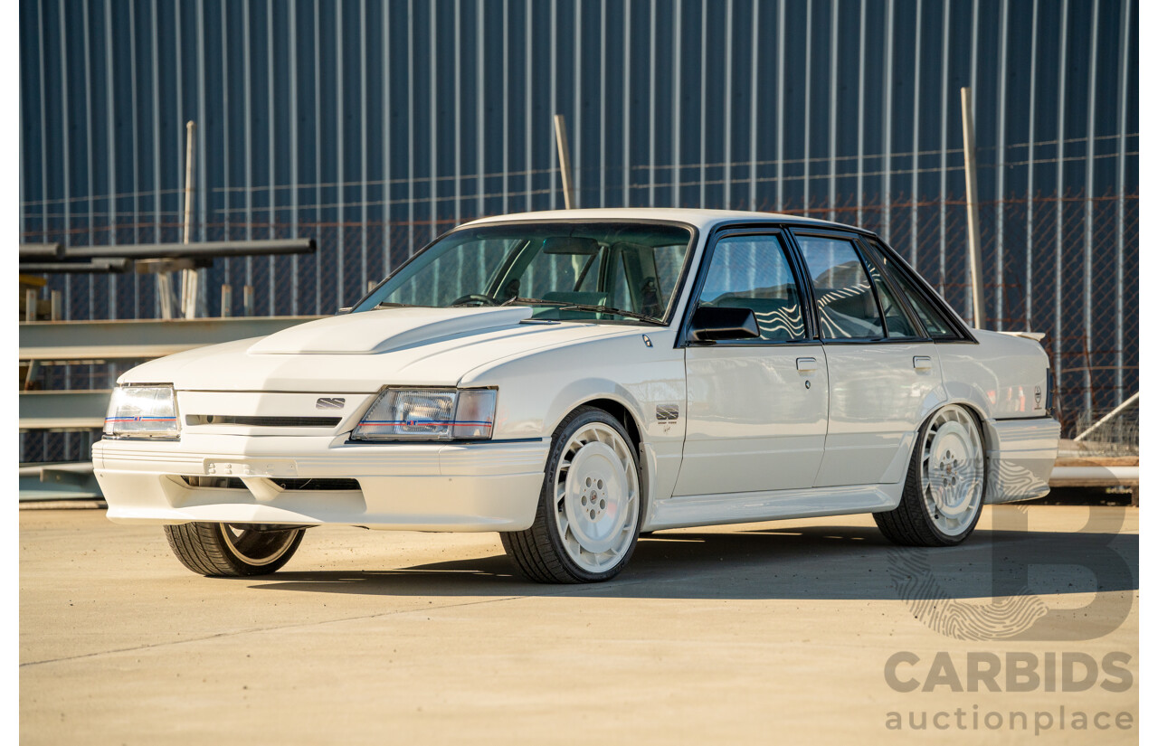 10/1984 Holden VK Commodore SL (134 Package) Group 3 Tribute 4d Sedan Alpine White V8 5.0L - Modified