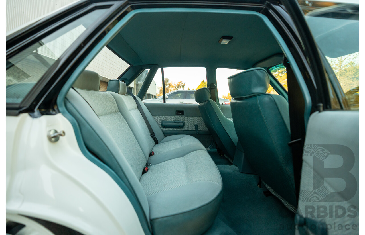 10/1984 Holden VK Commodore SL (134 Package) Group 3 Tribute 4d Sedan Alpine White V8 5.0L - Modified