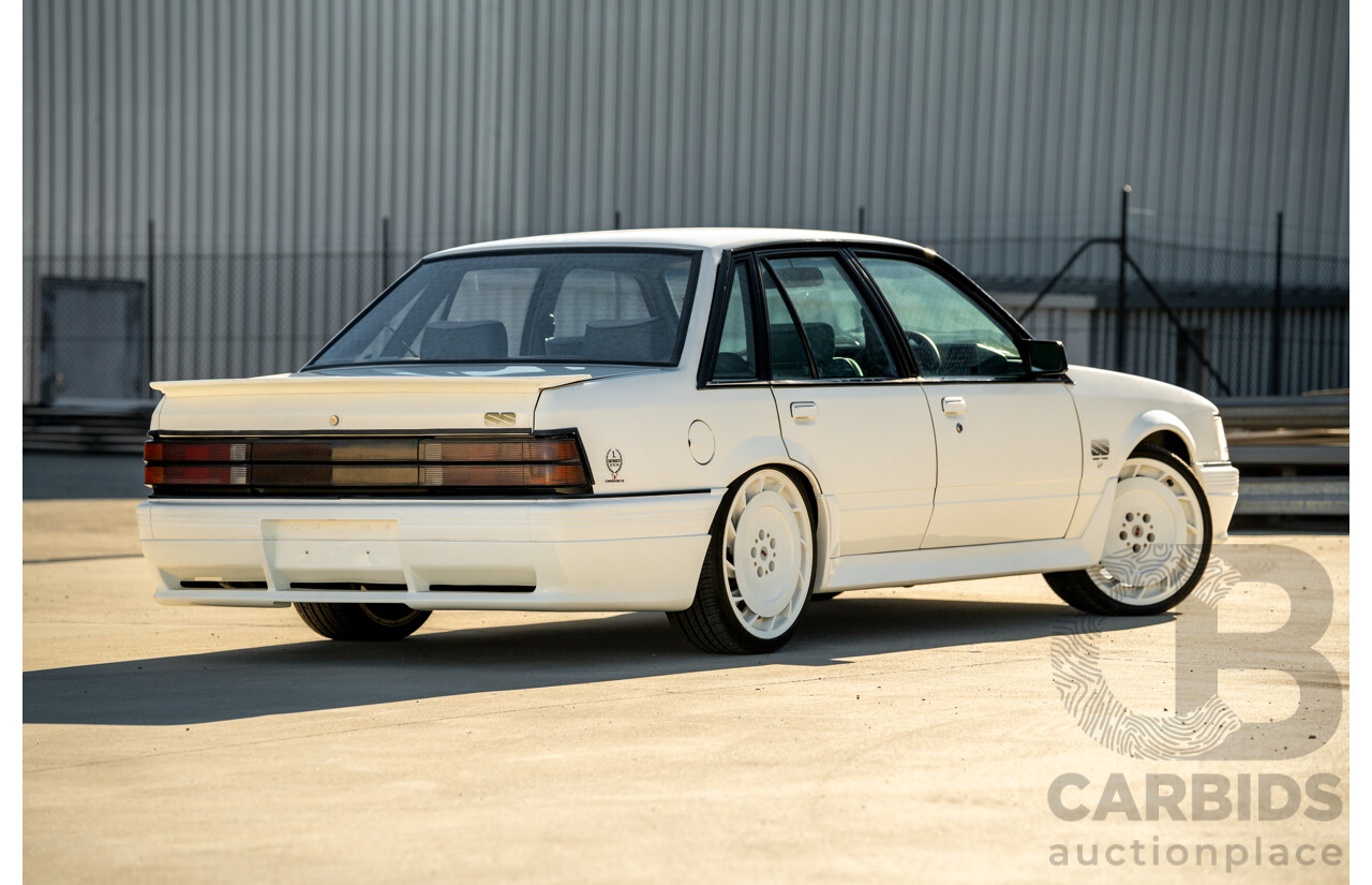 10/1984 Holden VK Commodore SL (134 Package) Group 3 Tribute 4d Sedan Alpine White V8 5.0L - Modified